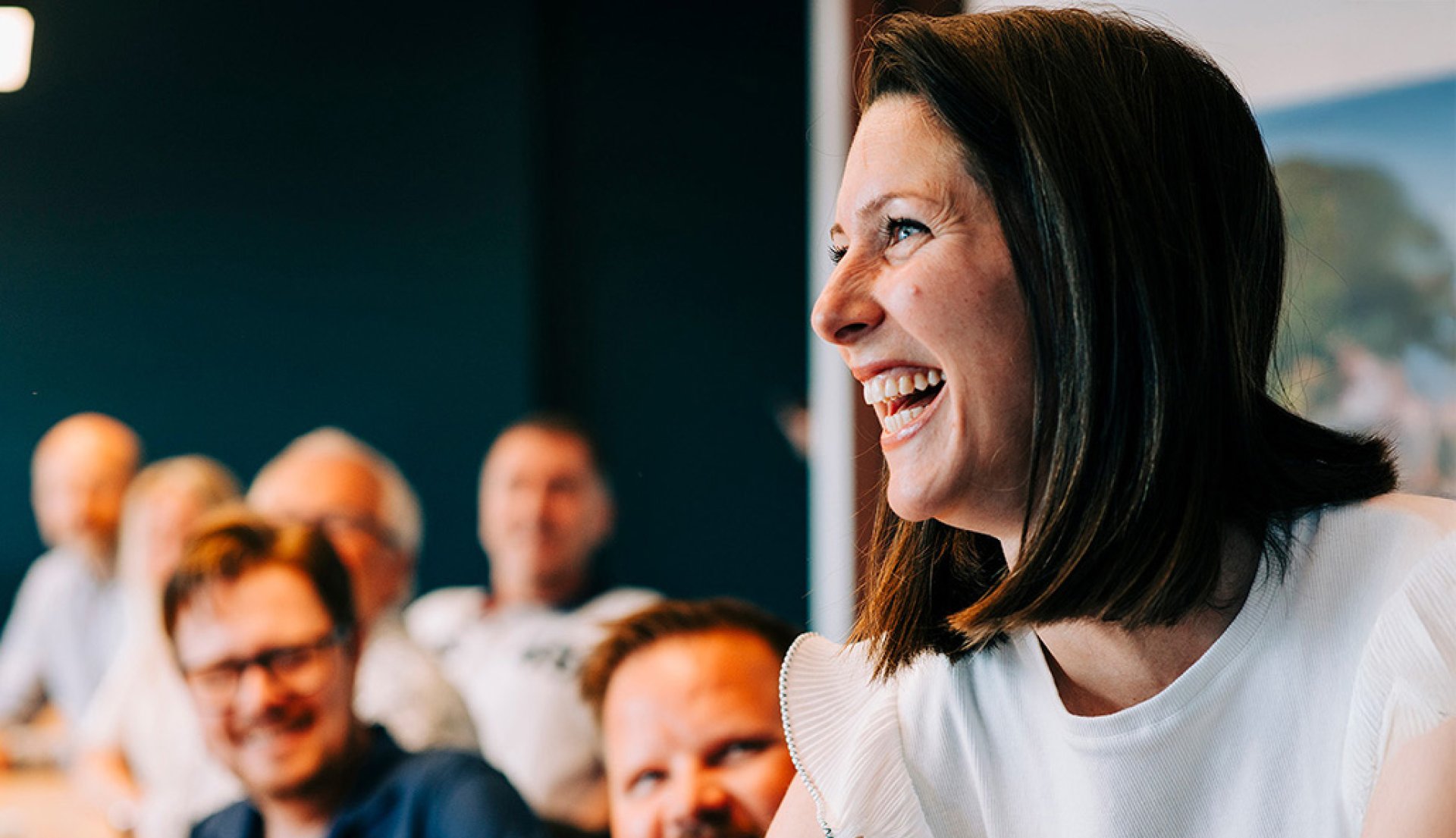 Jotron employees in a meeting room smiling.