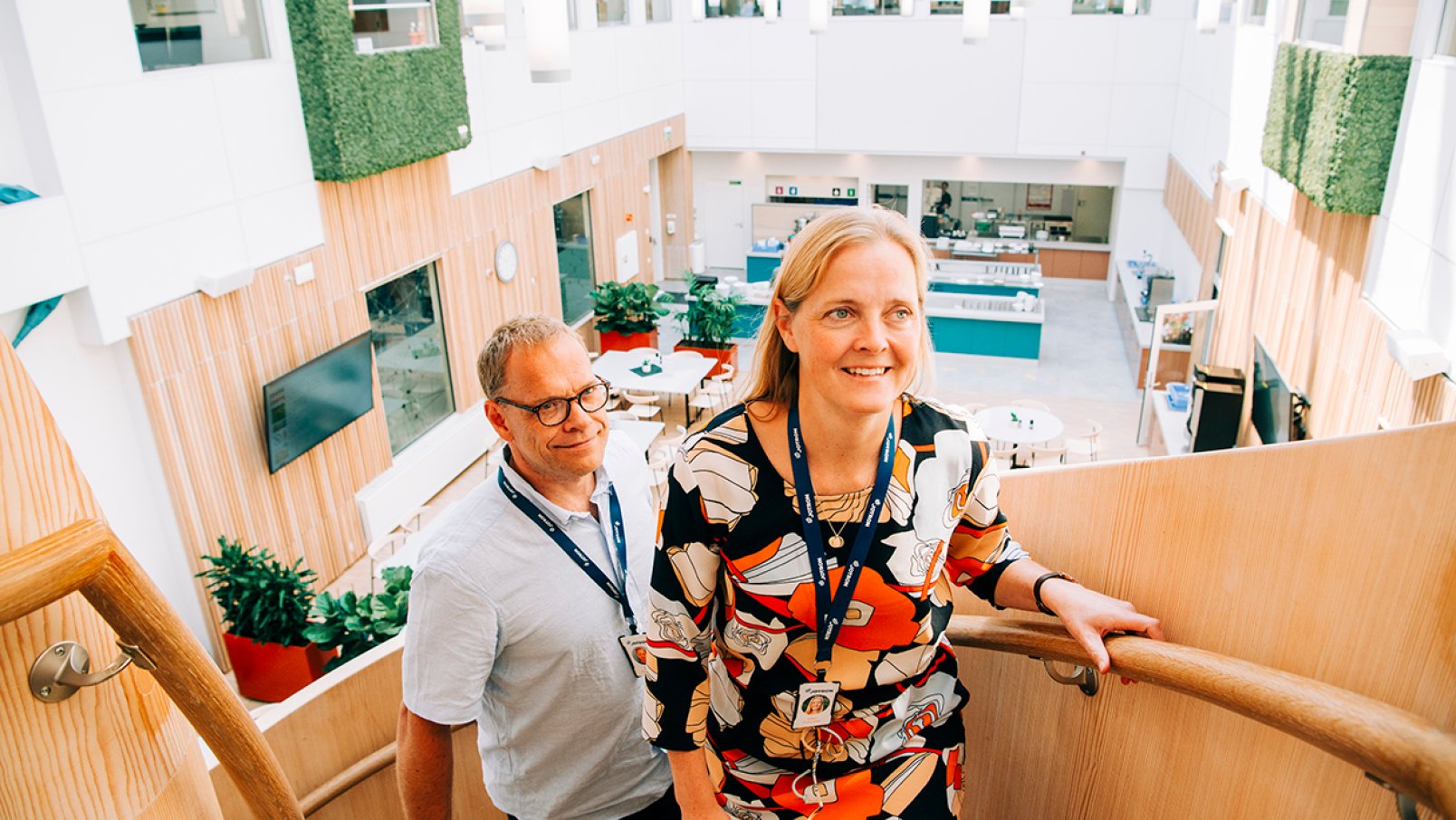 Two Jotron employees are going up the stairs from the canteen.