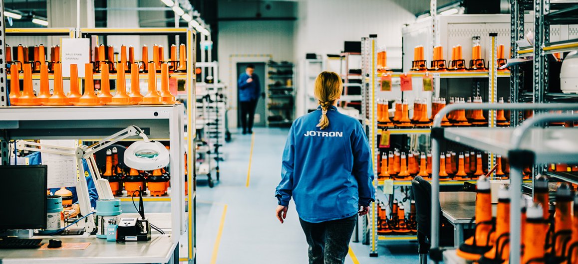 Jotron employee walking through the production department.