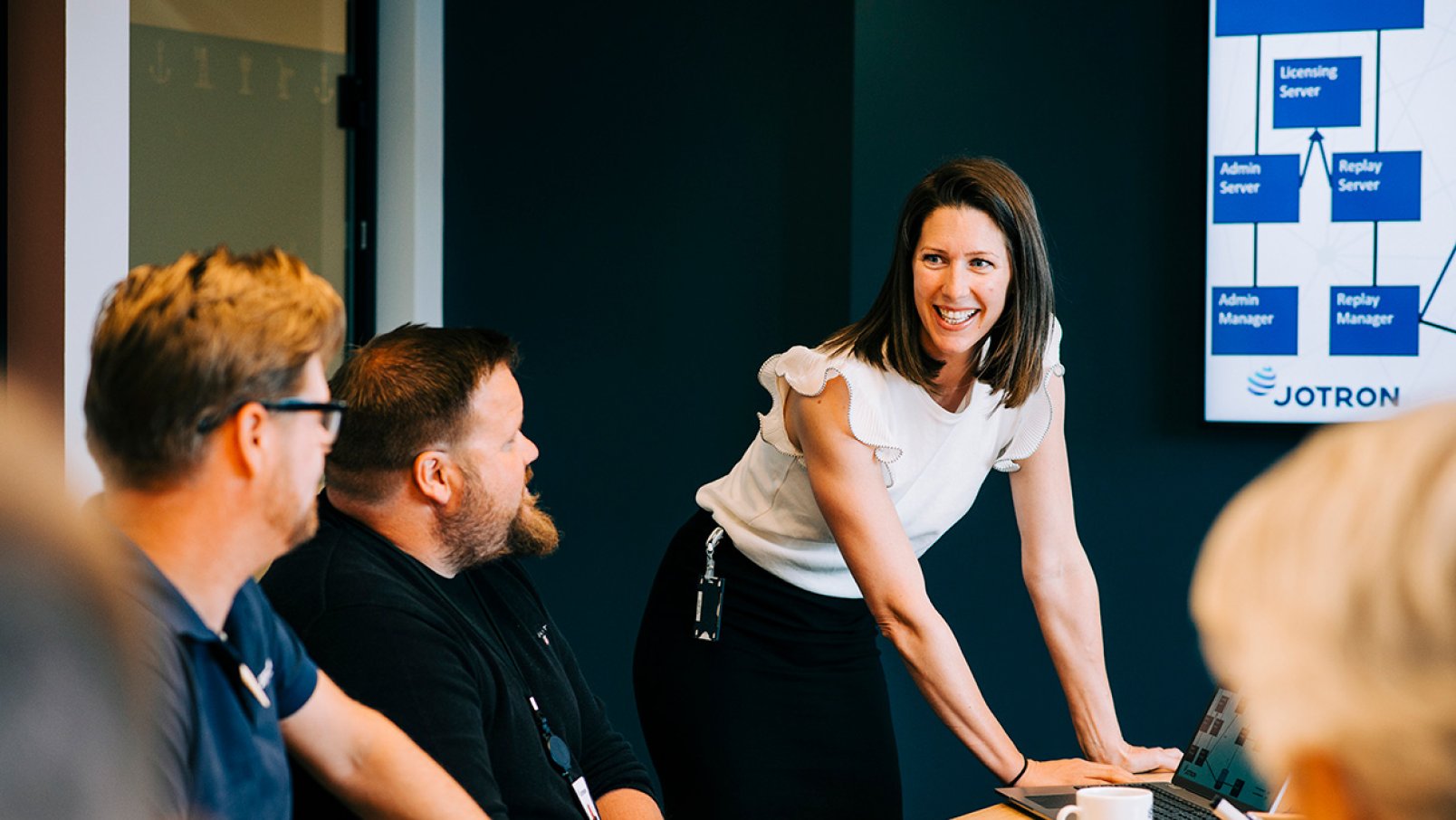 Jotron employees sitting in a meeting.