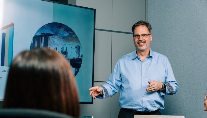 A Jotron employee doing a presentation in a meeting room.
