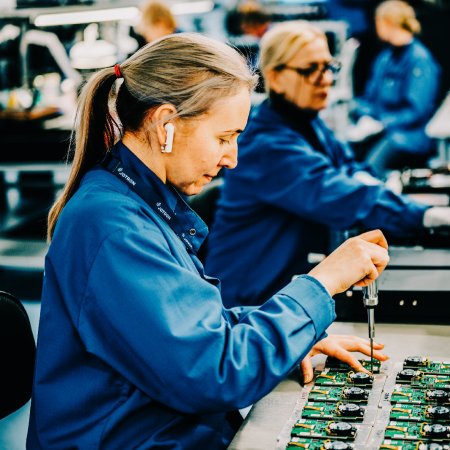 Jotron employee working on a circuit board. Jotron employee working on a circuit board.