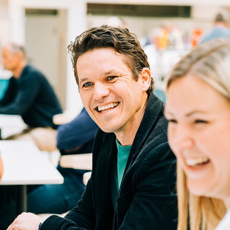 Two smiling Jotron empolyees in the company's canteena. Two smiling Jotron empolyees in the company's canteena.