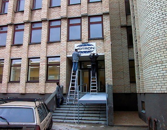 Mounting the Jotron sign outside the factory in Kaunas. Mounting the Jotron sign outside the factory in Kaunas.