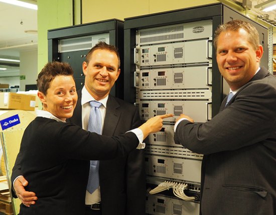 Jotron employees standing in front of a ATC radio rack. Jotron employees standing in front of a ATC radio rack.