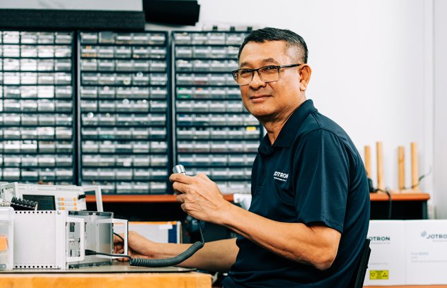A Jotron employee with a microphone testing a ATC radio. A Jotron employee with a microphone testing a ATC radio.