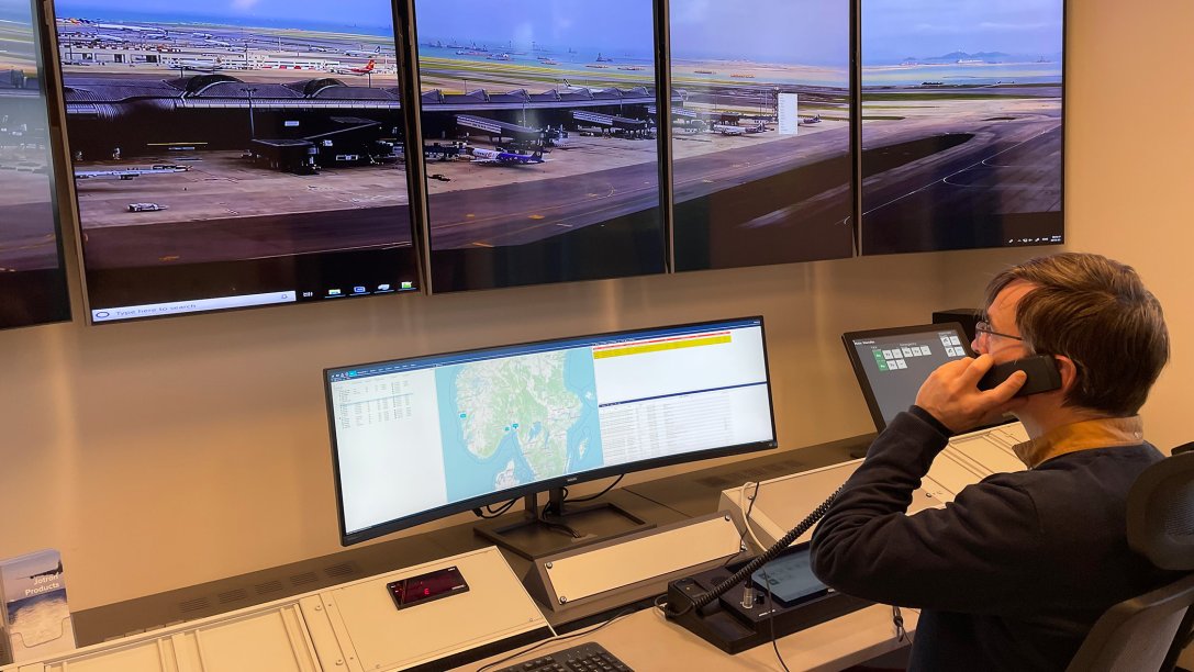 Person in front of monitors, operating in a ATC remote tower.