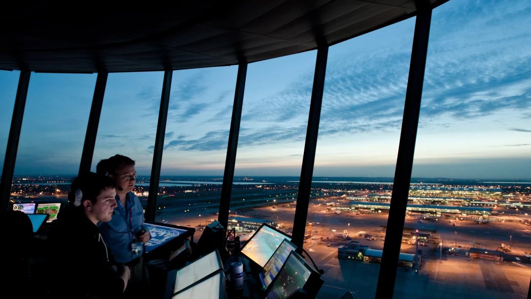 Two ATC controllers inside Heathrow Airport ATC tower.