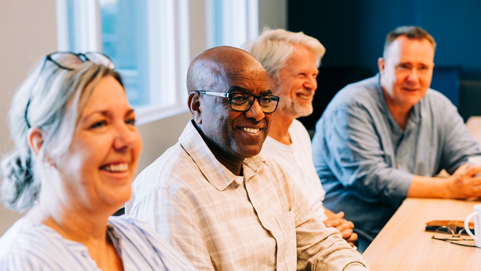 Smiling Jotron employees in a meeting.