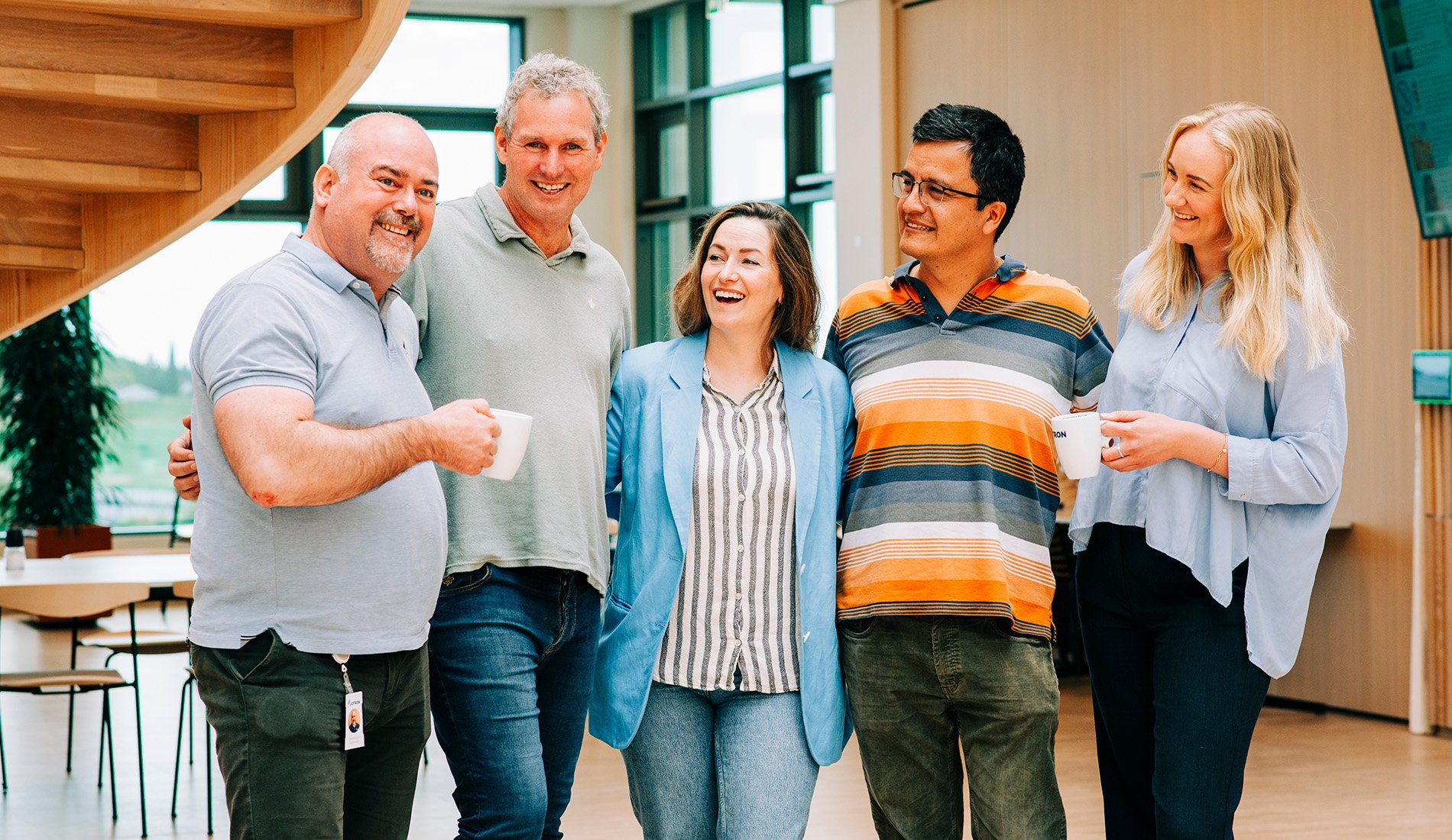Smiling Jotron employees in the cantina.