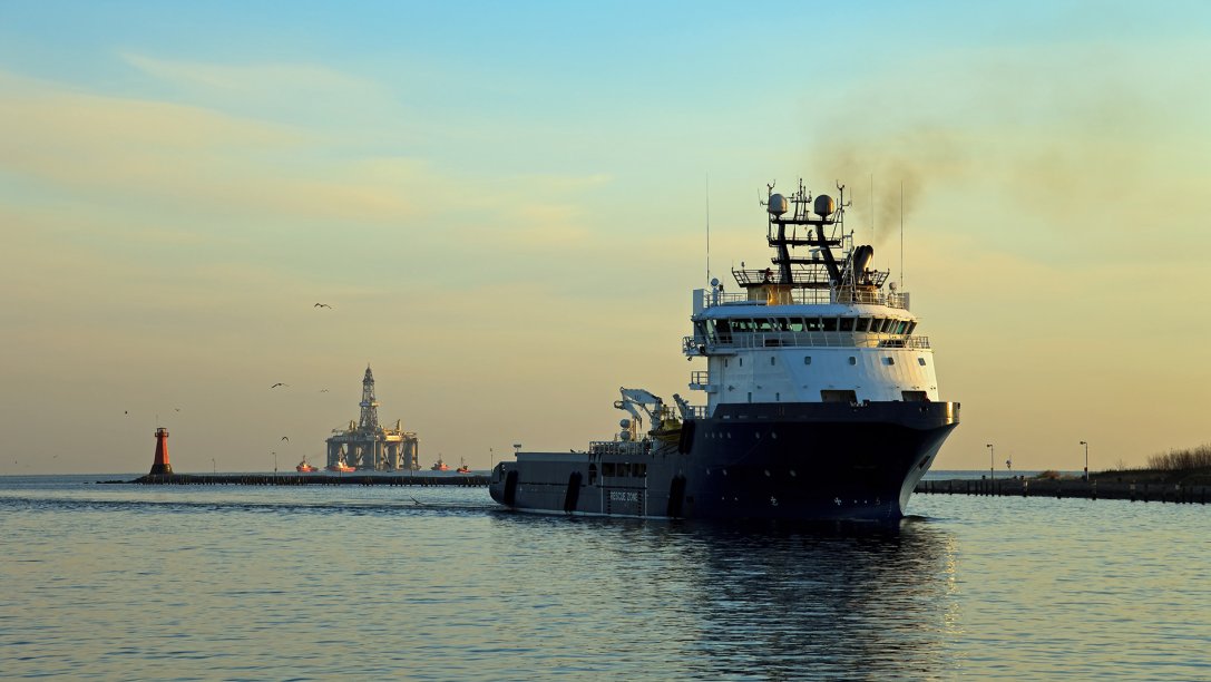 Supply boat and in front of a oil rig.