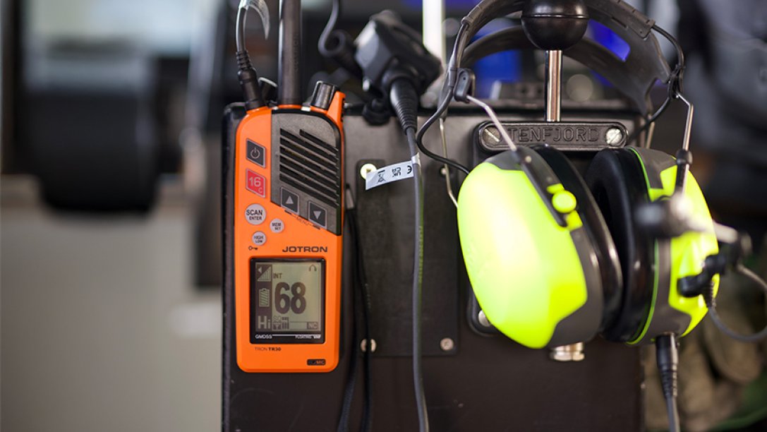 Tron TR30 handheld GMDSS radio with headset.