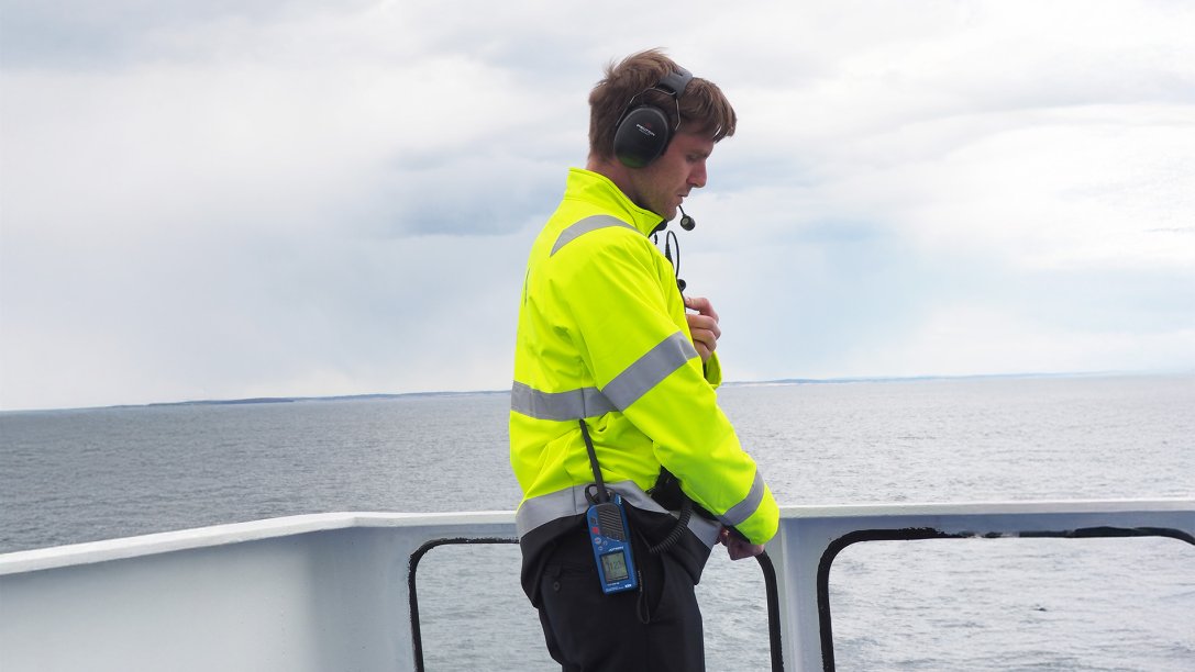 Man with a Tron TR30 AIR and headset, standing on the deck.