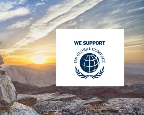 Mountains illustrating sustainability and the United Nations Global Compact logo.