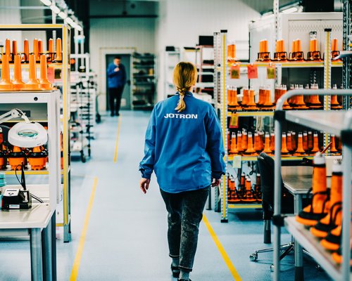 Jotron employee walking through the production department.