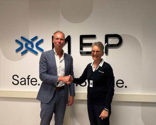 Werner Van Eck and Merete Berdal shaking hands.