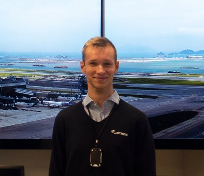 Jotron employee in front of large ATC screens in the company's demoroom.