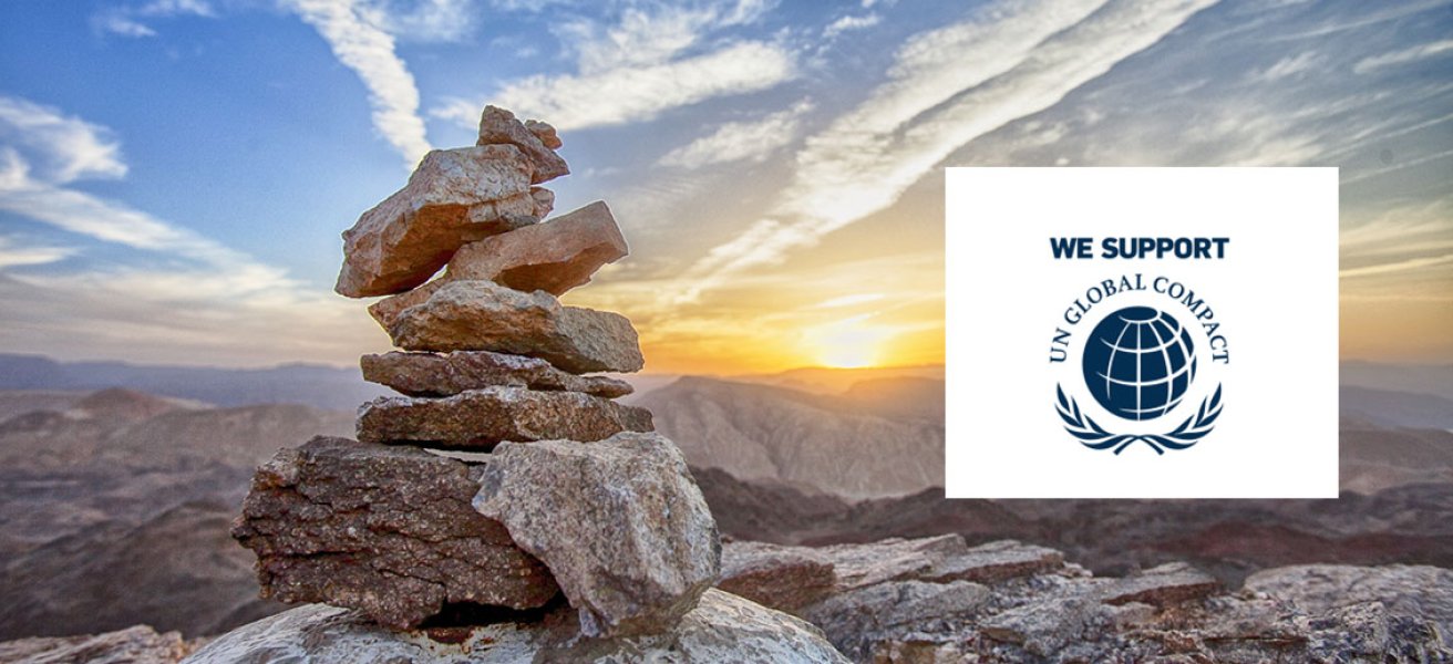 Mountains illustrating sustainability and the United Nations Global Compact logo.