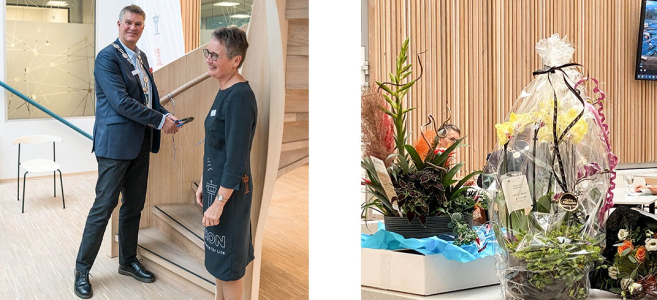 The Mayor of the city of Larvik Erik Bringedal and Merete Berdal open the new Jotron office, in front of a table with flowers and gifts.