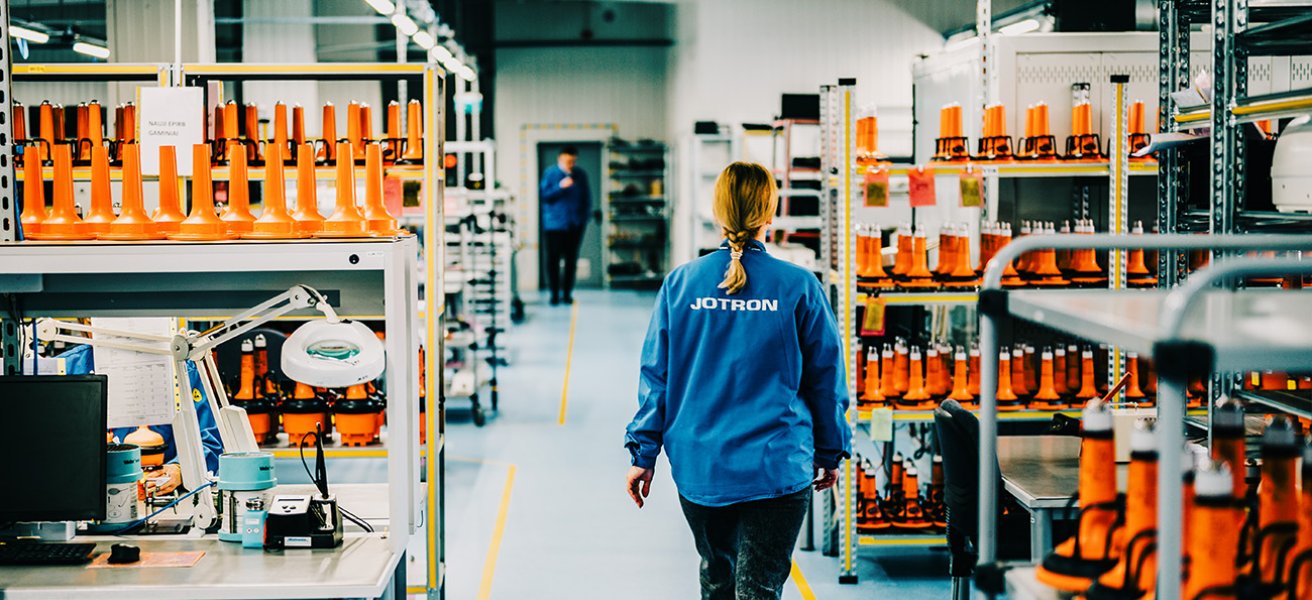 Jotron employee walking through the production department.