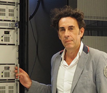 Jotron employee in front of a rack with ATC radios.