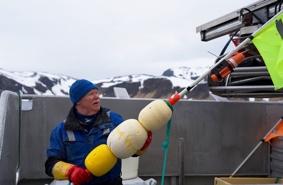 Fisherman with TronTracker mounted on marker pole.