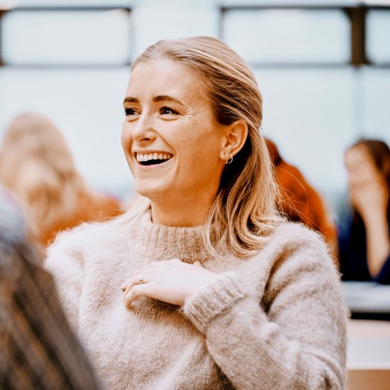 Jotron employee sitting down and smiling. Jotron employee sitting down and smiling.
