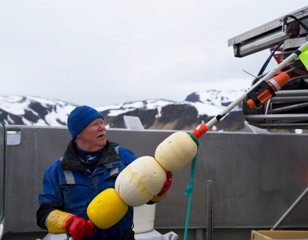 Fisherman with TronTracker mounted on marker pole. Fisherman with TronTracker mounted on marker pole.