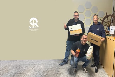 Three employees from Querin GmbH holding Jotron products.
