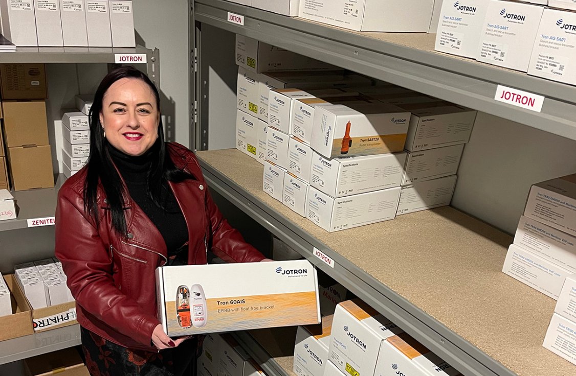 Lady showing JRC Iberia's products in the warehouse.